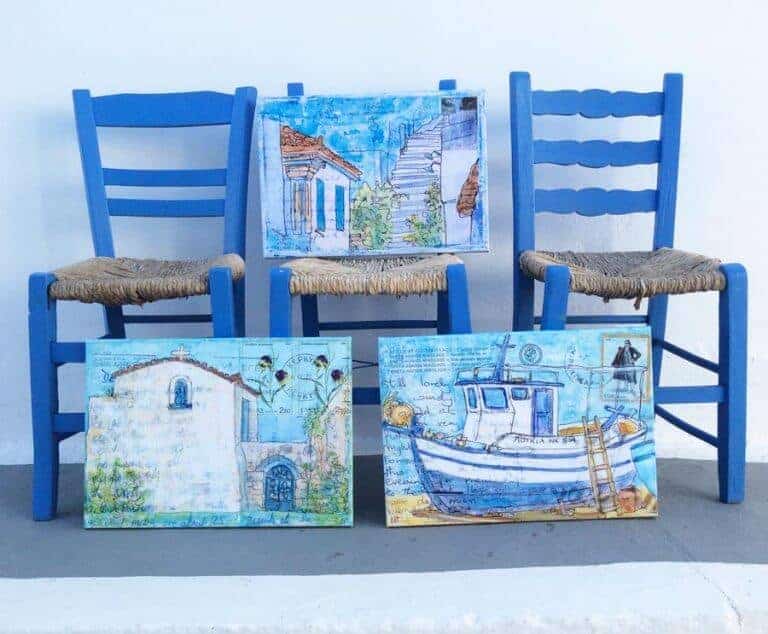three blue greek taverna chairs with three canvases of greek art