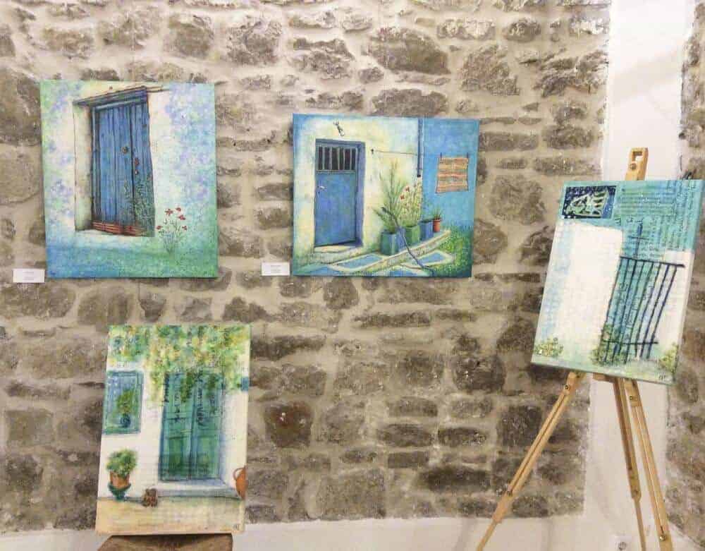 new mixed media paintings and giclee canvas reproductions by english artist gill tomlinson on display at an exhibition in Methoni, Greece